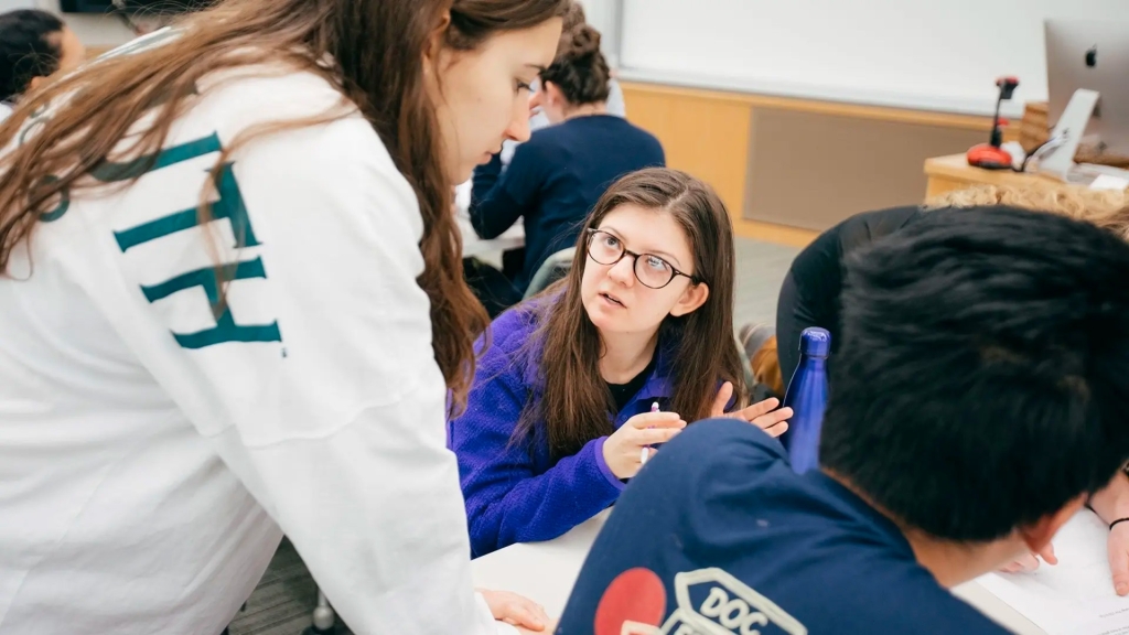 Teacher working with students on campus